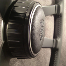 Porsche Hockey Puck on leather wrapped steering wheel